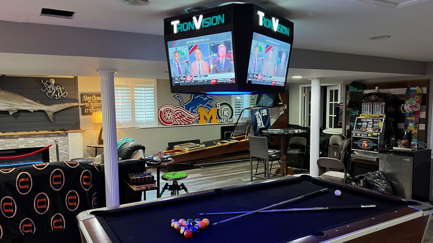 TronVision multi-screen display for home entertainment, featuring a seamless arrangement of vibrant screens showcasing movies, games, and digital content in an immersive setup.